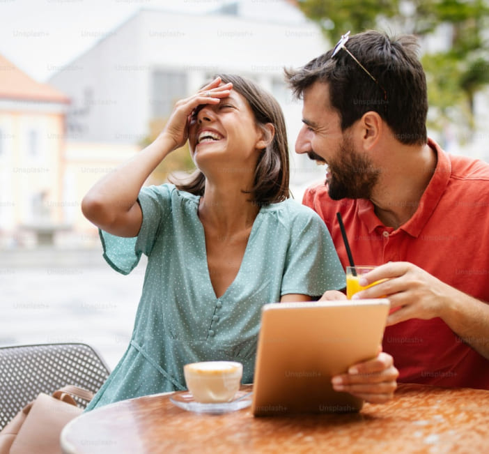 Image Of A Men And Women Seating On A Table